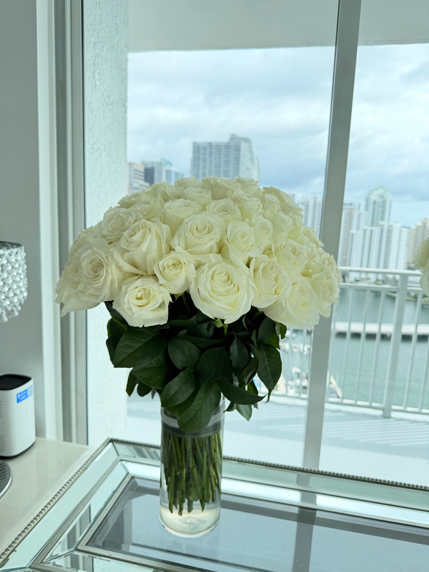 80 white roses dome arrangement overlooking Miami skyline