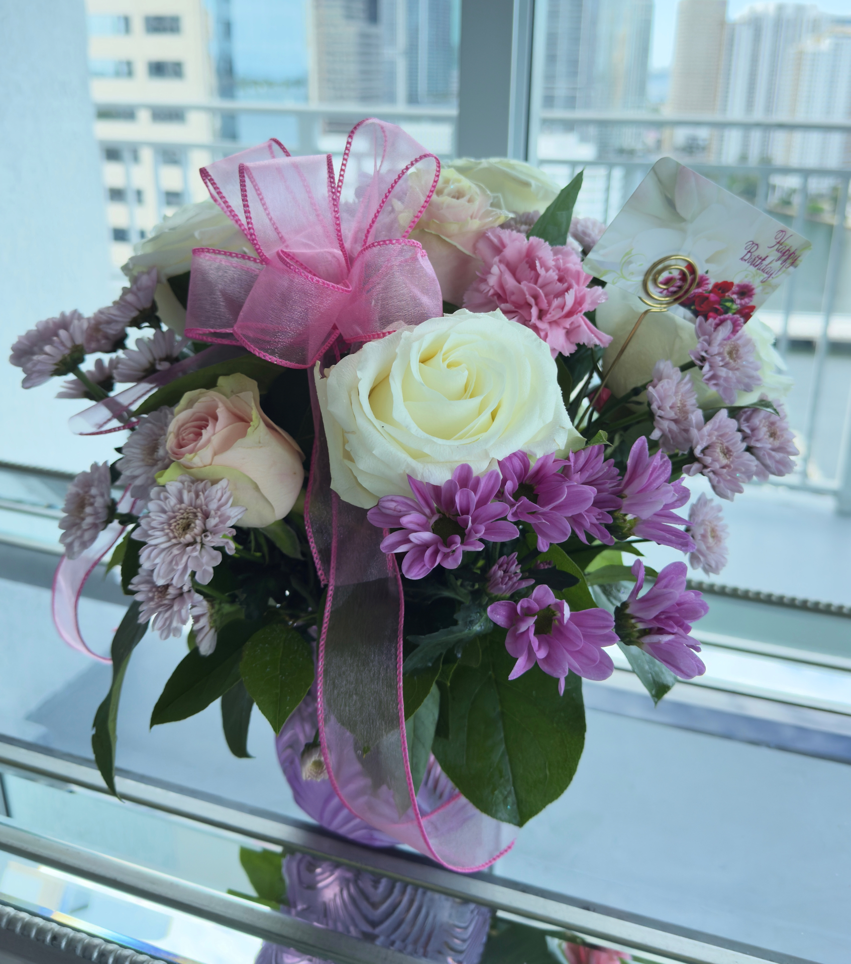 Pastel birthday arrangement on bayside balcony